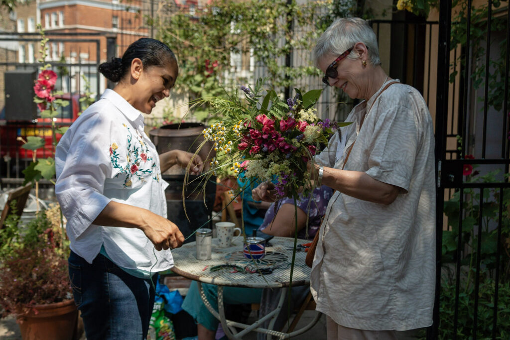 Volunteers at local charity, arranging flowers through funding on ActionFunder
