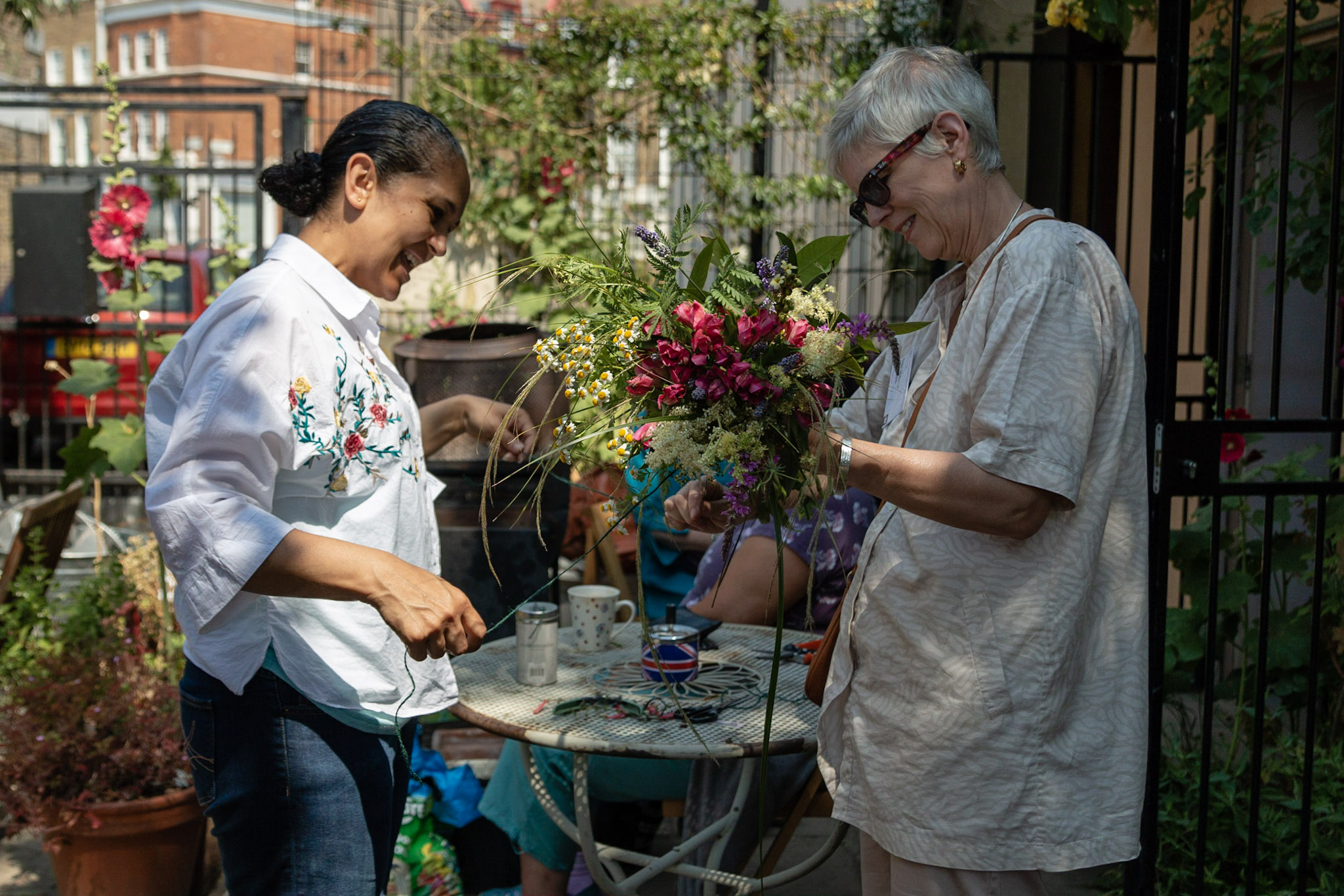 Volunteers at local charity, arranging flowers through funding on ActionFunder