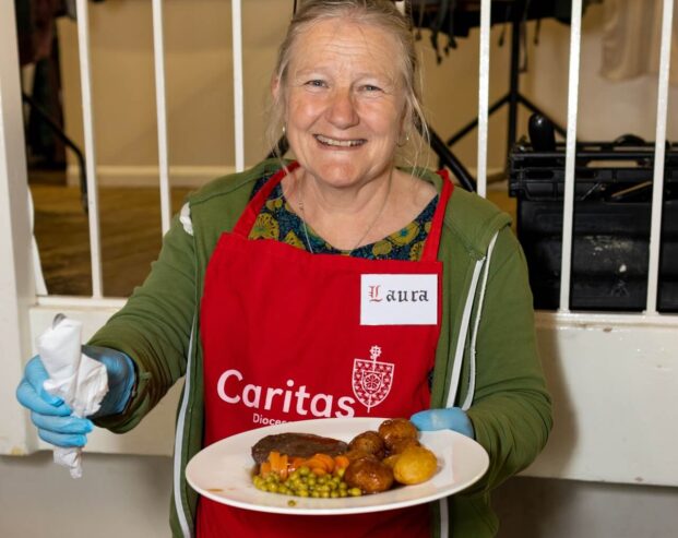 woman from non-profit non-serving hot meal as part of community group