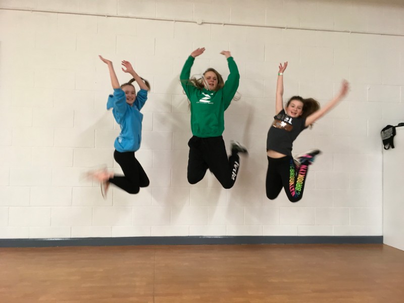 Children jumping at youth community charity