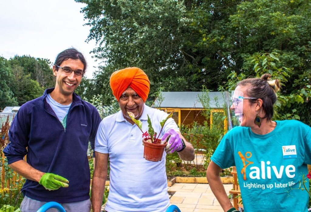 people smiling enjoying a community garden social value project