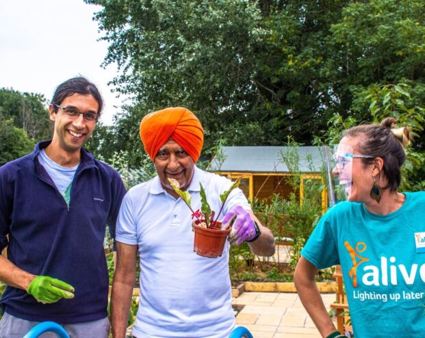 people smiling enjoying a community garden social value project