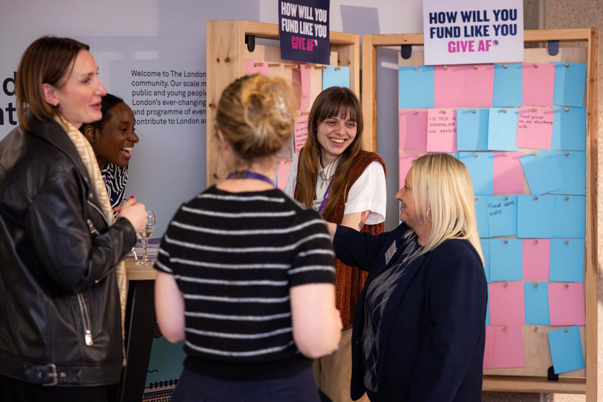 Attendees networking and laughing at an ActionFunder event